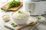 Perfectly cooked jasmine rice in a bowl with a rice cooker